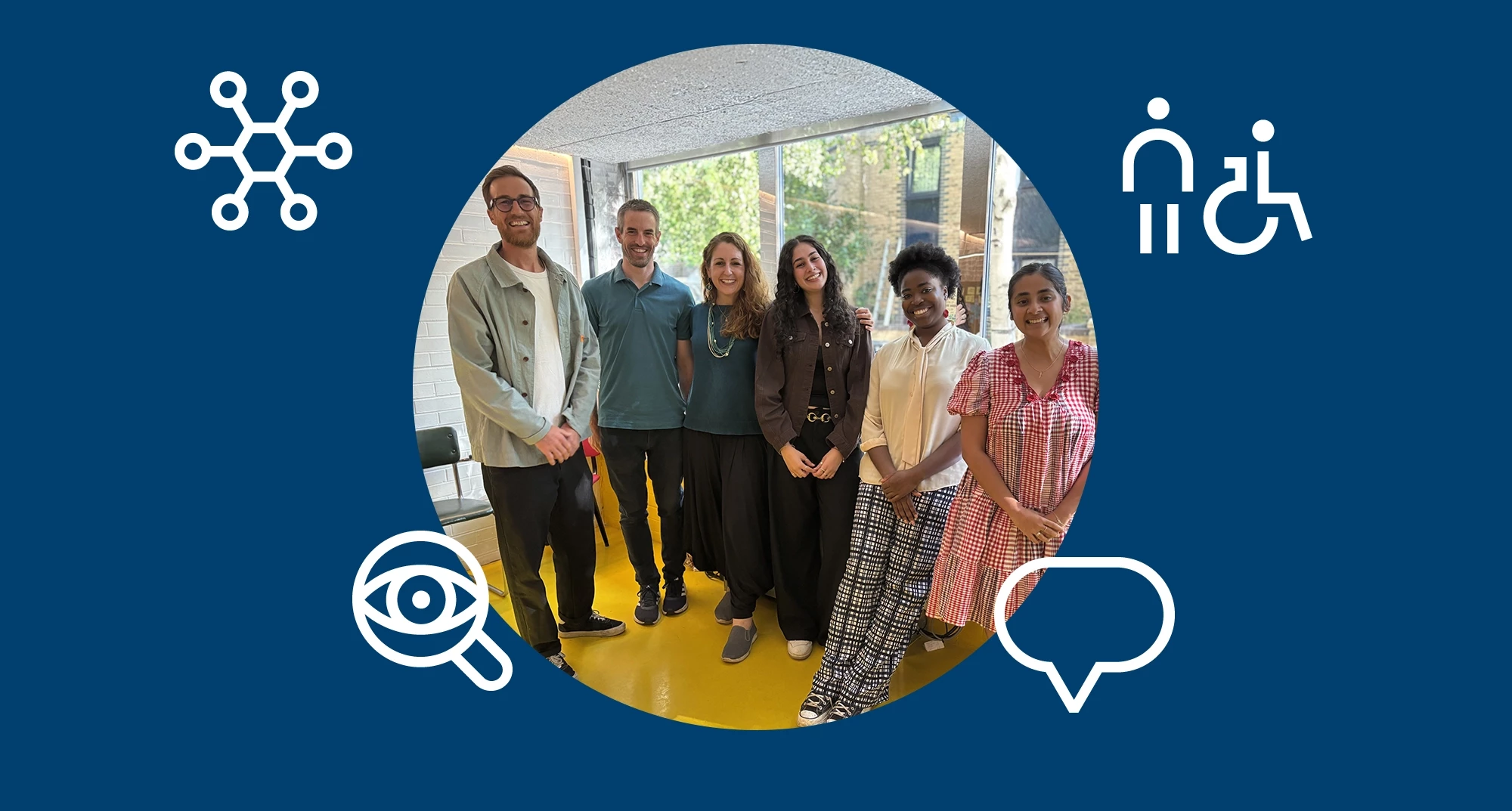 A group of six people standing together and smiling in a bright indoor space with large windows behind them. The photo sits within a circular frame on a blue background featuring simple white icons related to connection, accessibility, vision, and communication.