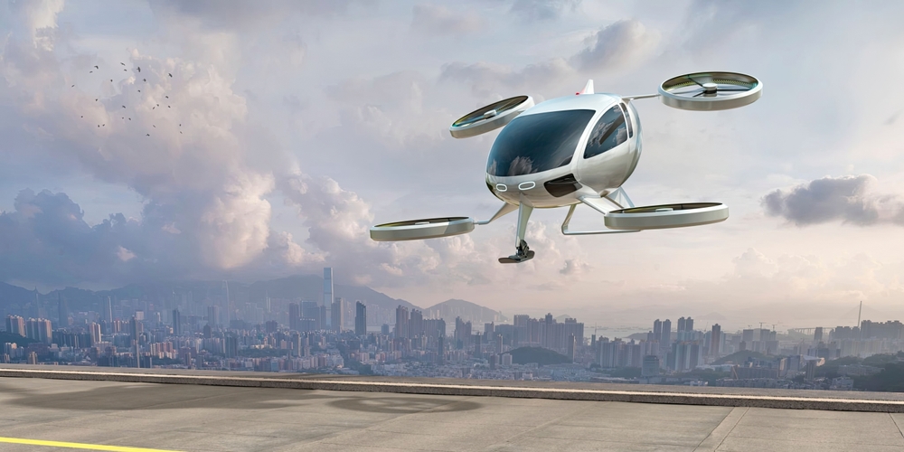 An image of an electric vertical take-off and landing (eVTOL) aircraft taking off in front of a cityscape